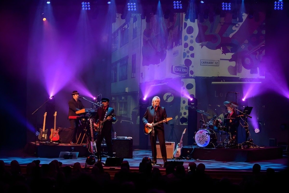 The British Invasion Years performing in front of a Carnaby Street backdrop