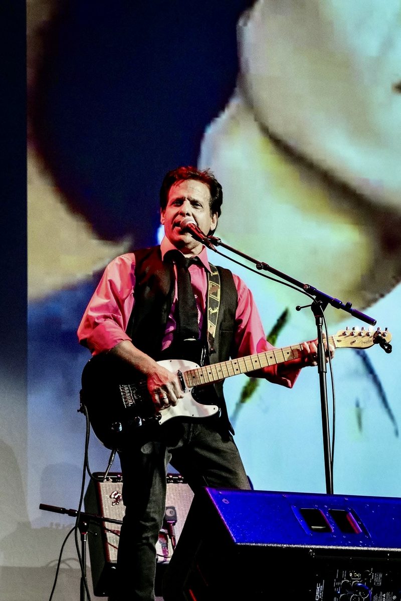 Joe LaFragola singing with a Telecaster in a black vest and red shirt