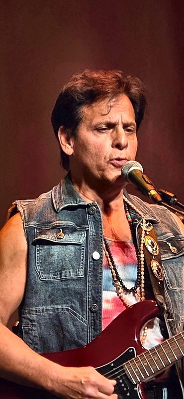 The British Invasion Years, Joe LaFragola at the microphone in a denim vest