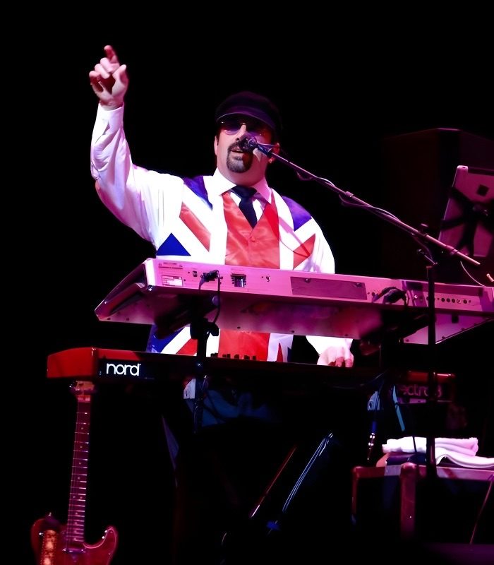 Jon Wolf in a Union Jack vest at the keys